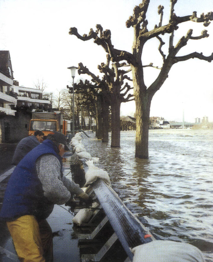 Emergency workers securing Geodesign flood barriers along Uferstrasse in Rodenkirchen, Cologne, during the February 1999 Rhine flood.
